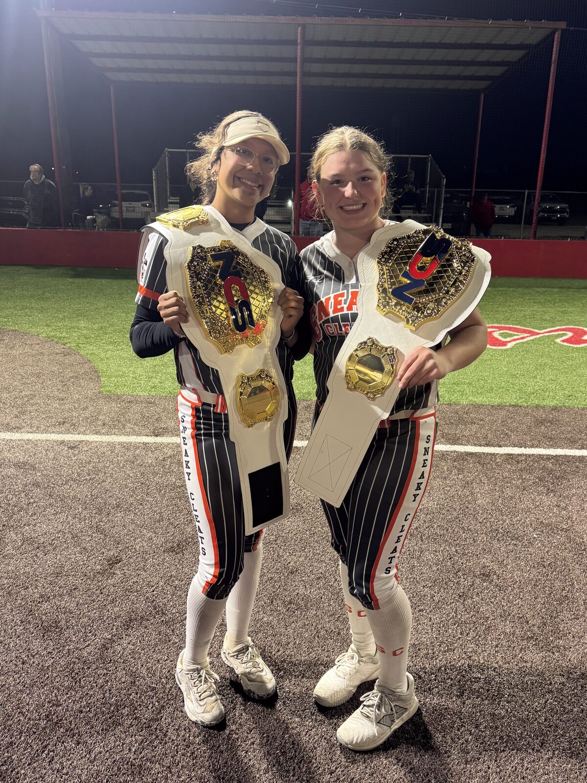 Adeline Camden with NCS championship belts