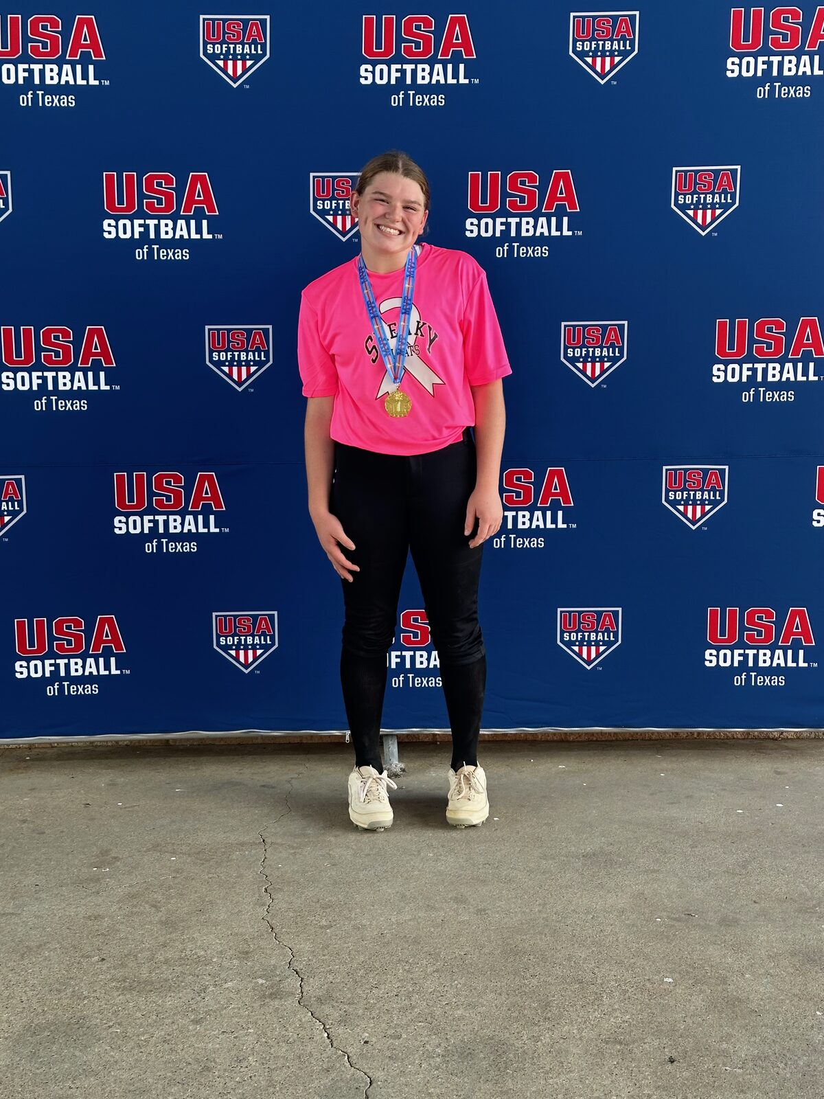 Adeline Camden at USA Softball of Texas with gold medal