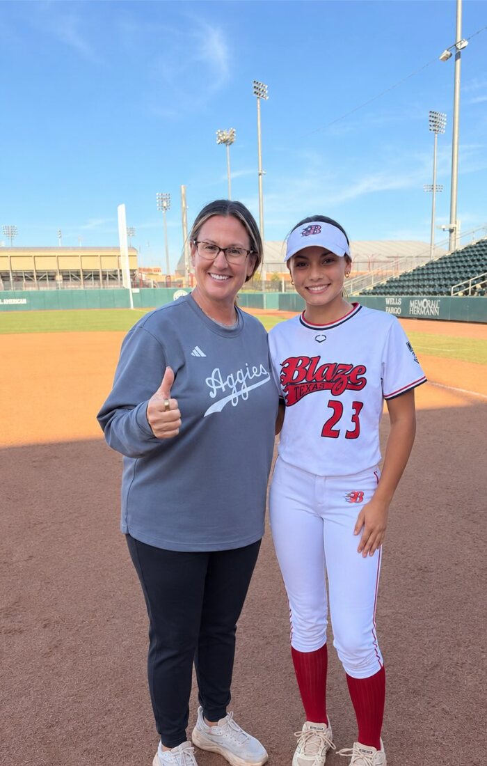 Adryn Bertling with a coach on the field at Texas A&M